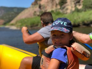 kid smiling from kayak